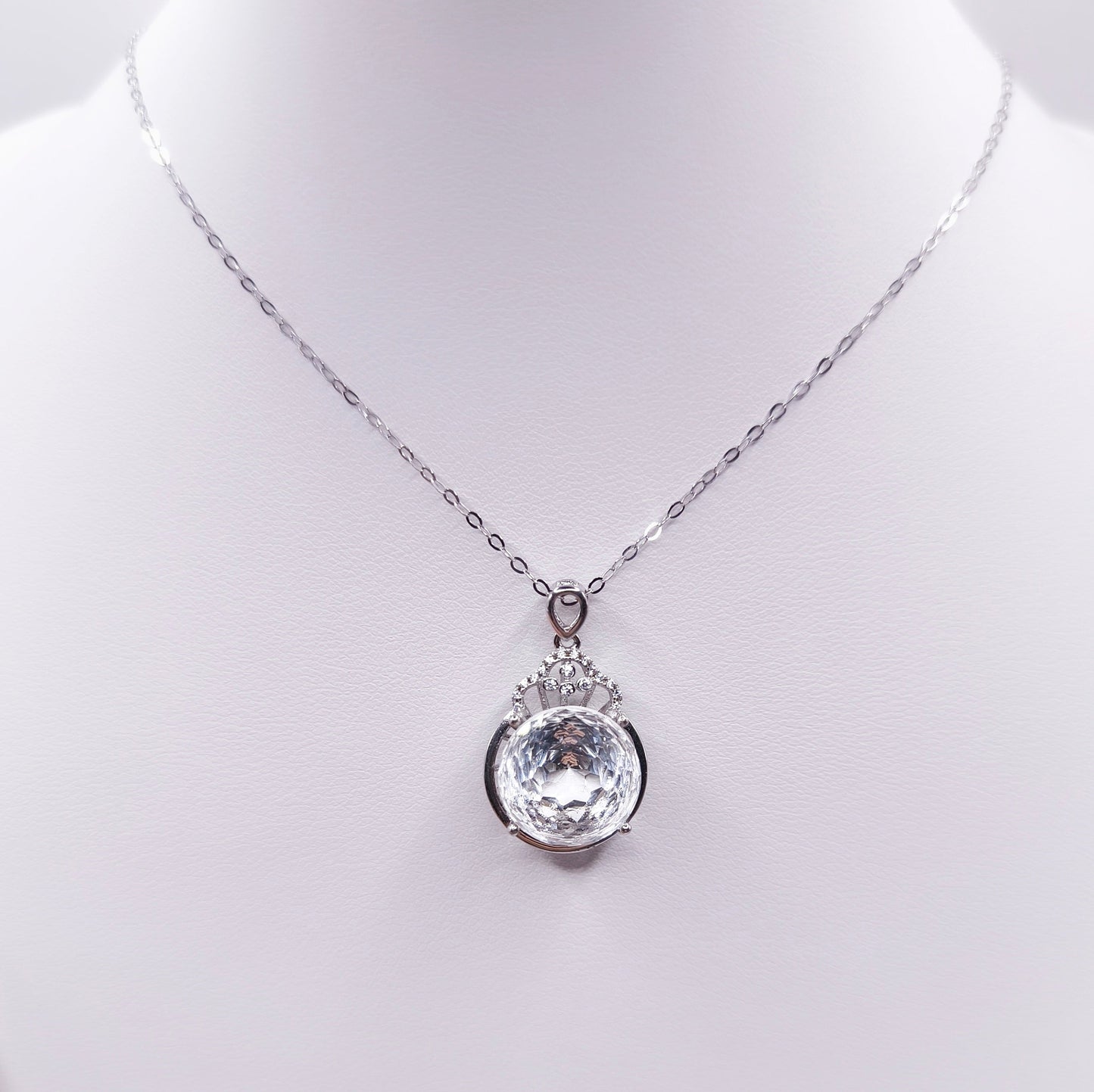 Sterling silver necklace with a polished clear quartz pendant