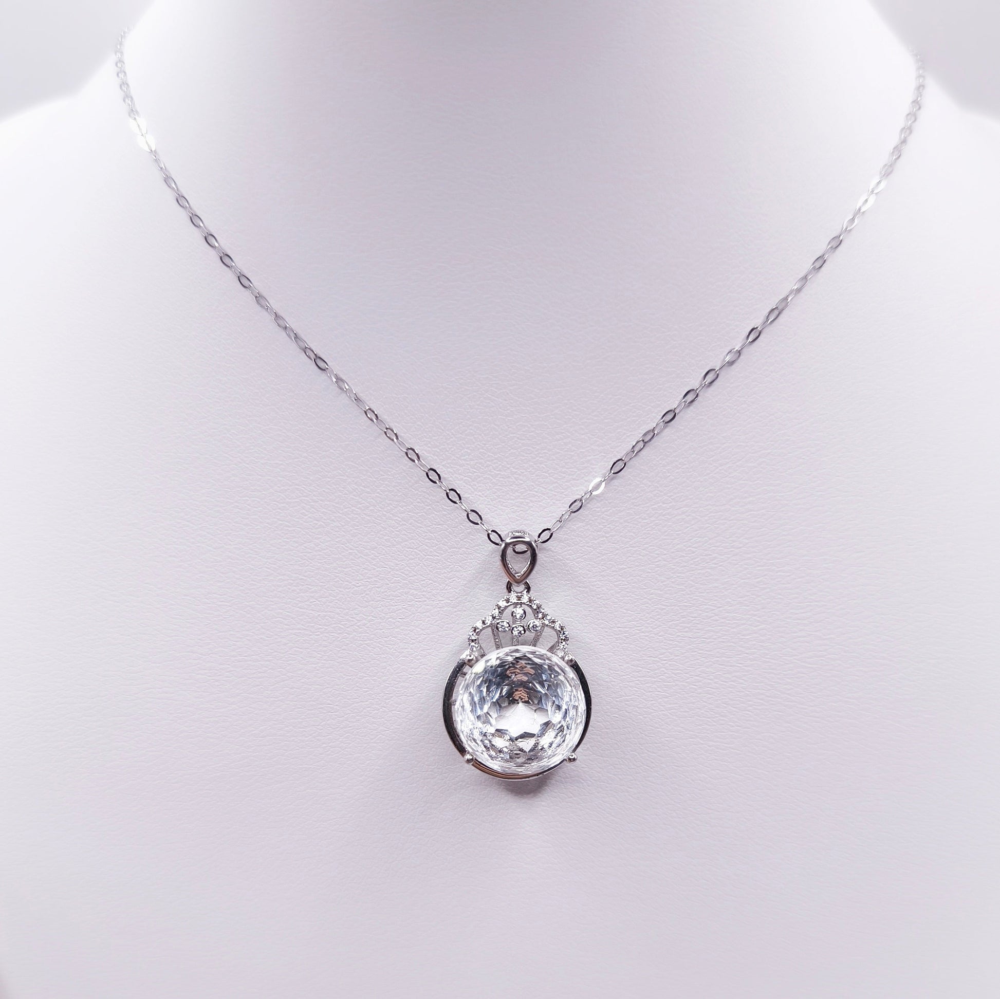 Sterling silver necklace with a polished clear quartz pendant
