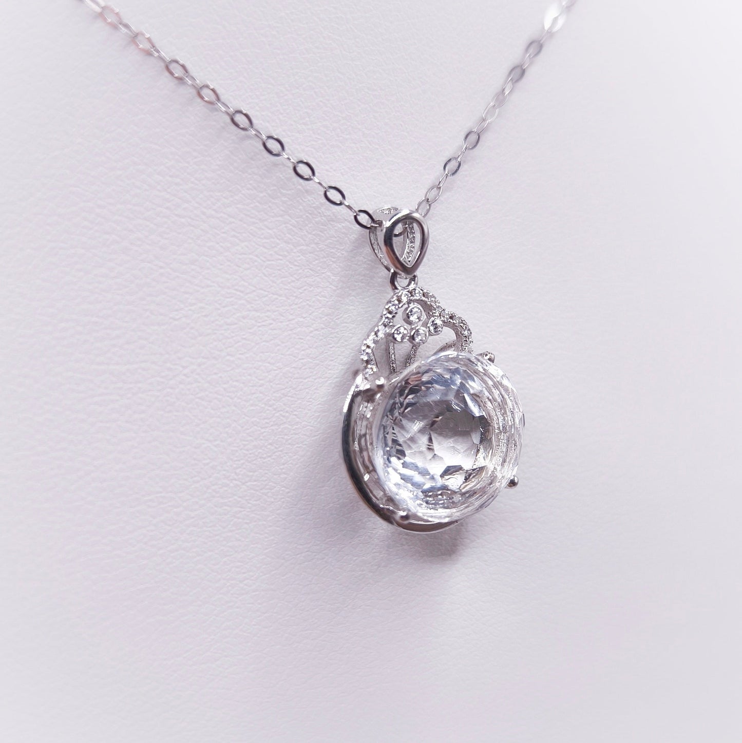 Sterling silver necklace with a polished clear quartz pendant