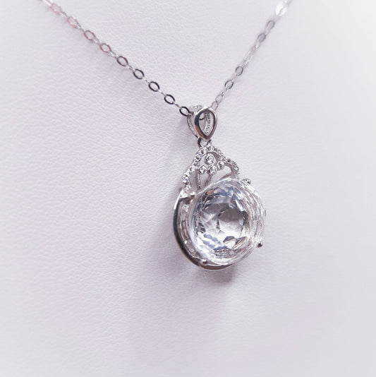 Sterling silver necklace with a polished clear quartz pendant
