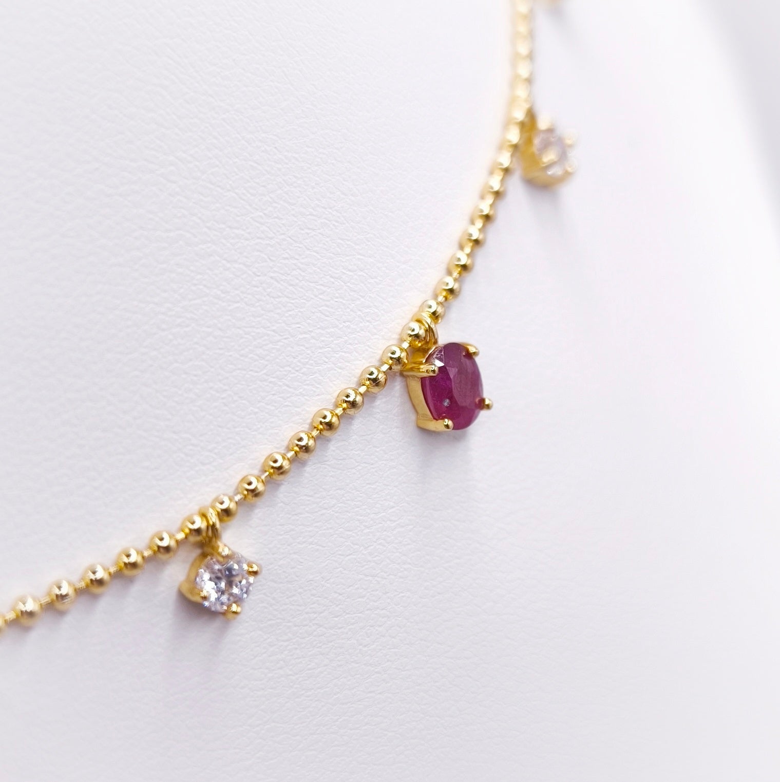 Gold plated sterling silver necklace with oval rubies and moissanite stones